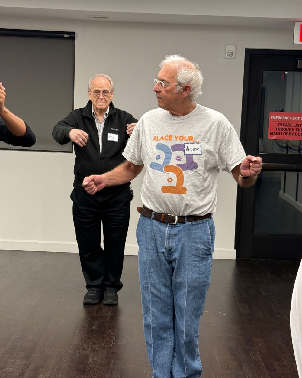 Two older members practicing a partner dance at the Pozez JCC